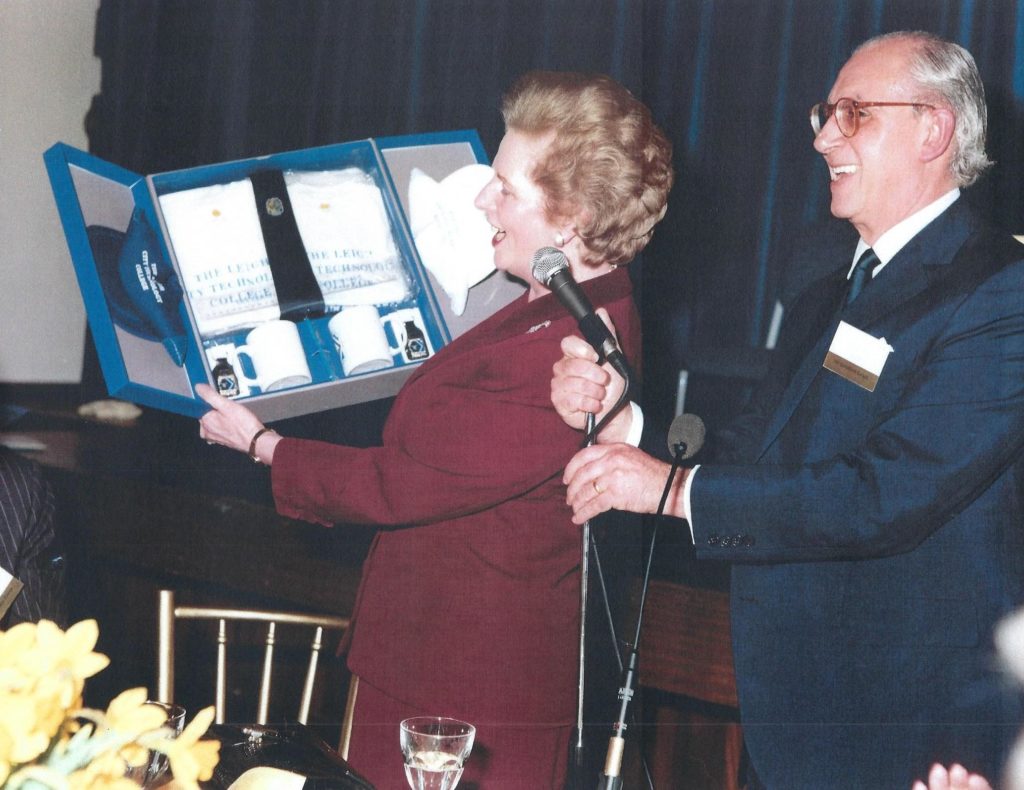 Two people holding commemorative items