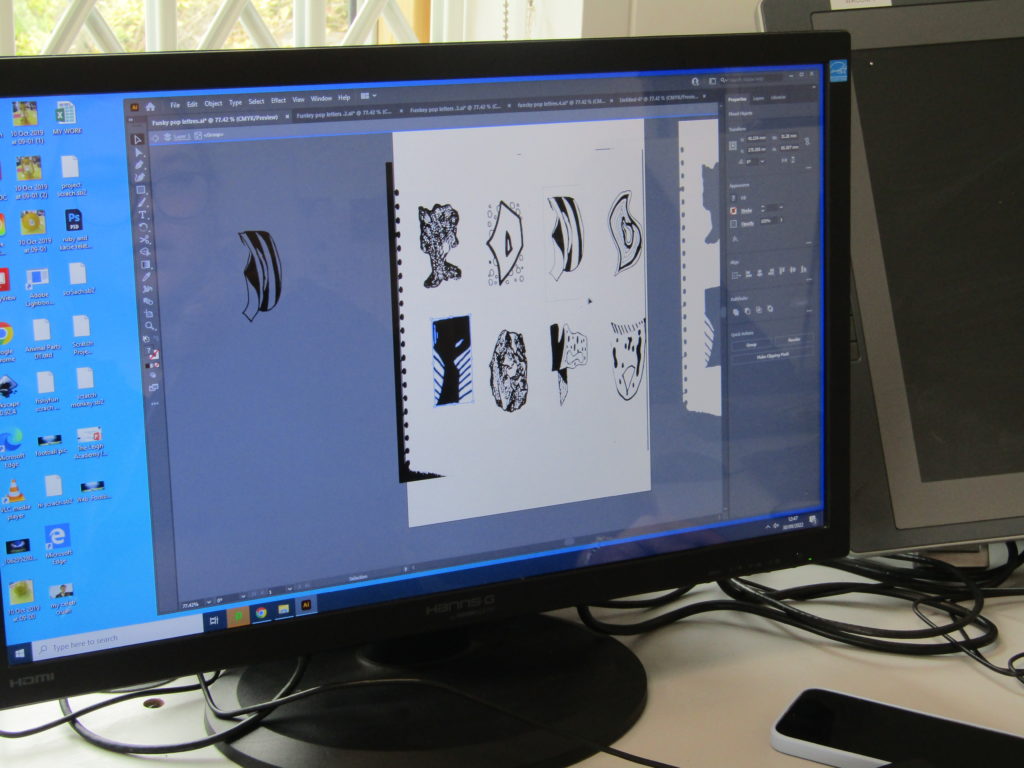 A piece of artwork can be seen being created by a student on a computer screen.