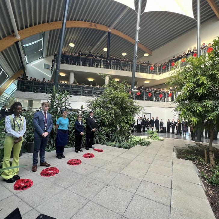 Students and staff at The Leigh Academy are photographed paying their respects during a one minute's silence in an open atrium area on Remembrance Day 2023.