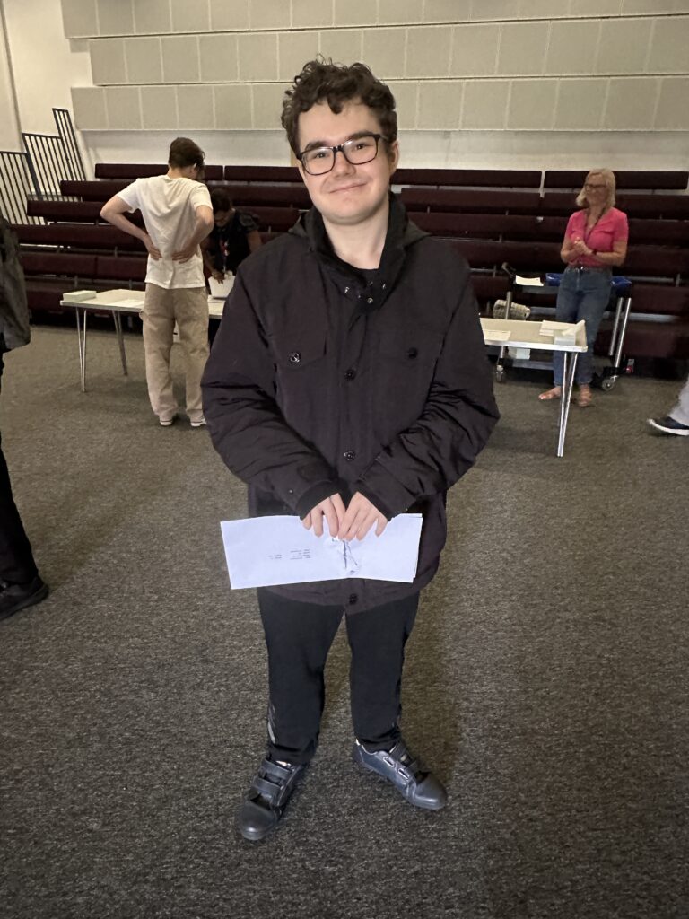 Sam holding their results.